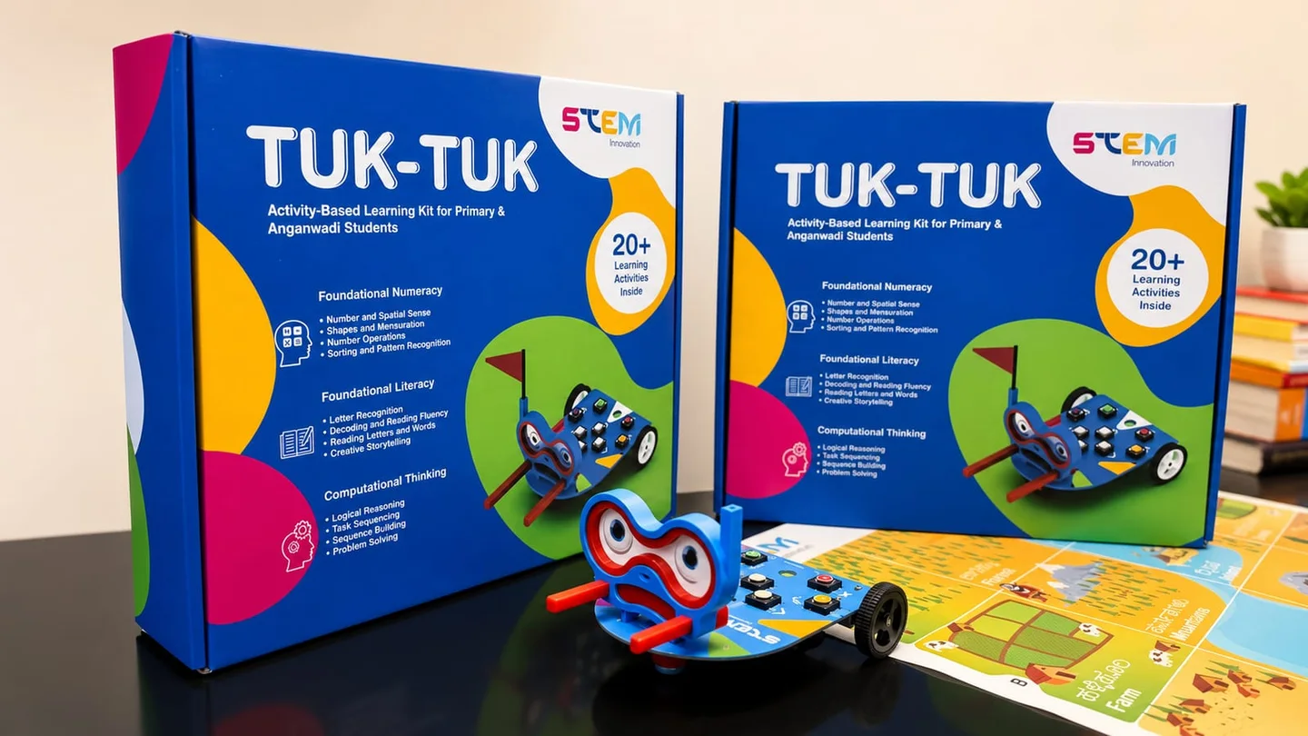 TUK-TUK robot beside its product boxes and a printed activity mat